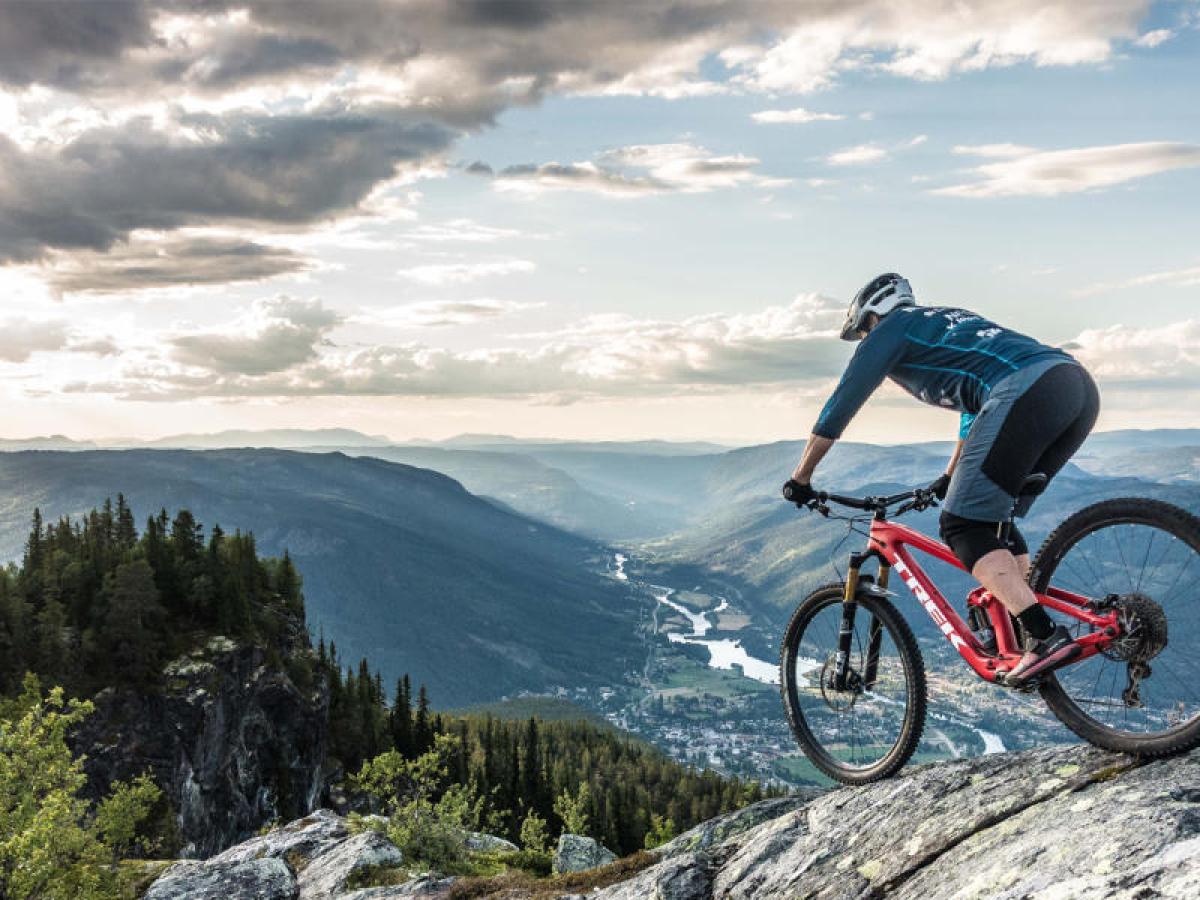 a man riding a bicycle on the side of a mountain